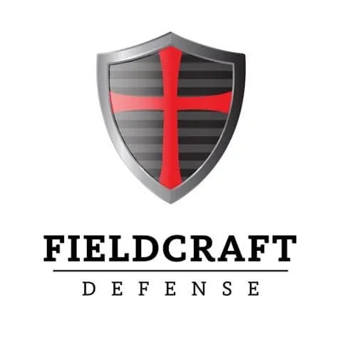 Fieldcraft Defense logo featuring a shield with red and black cross design, and the text "Fieldcraft Defense" below it.