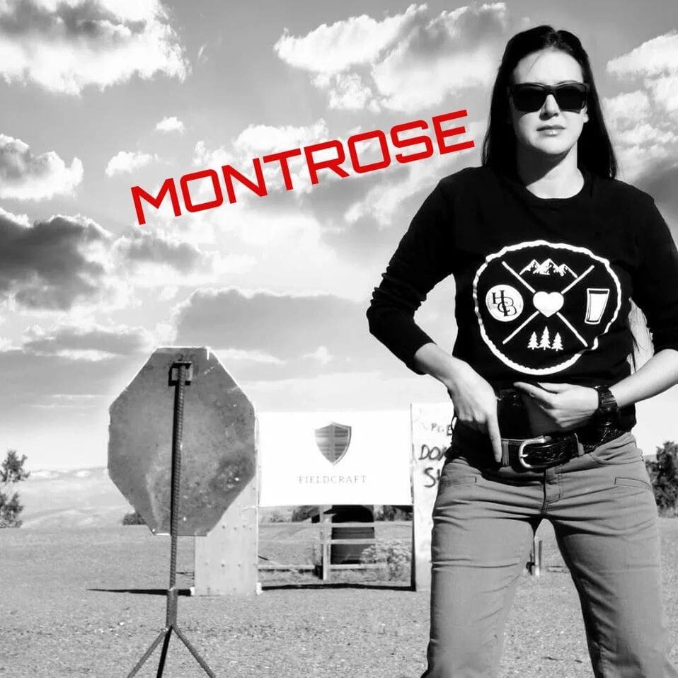 A woman standing in front of a stop sign.